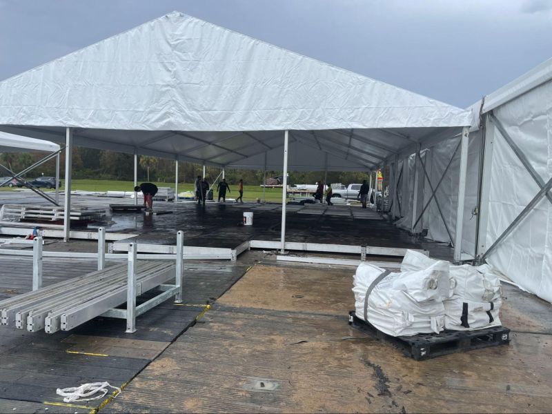 A large white frame tent showcasing safety‑focused groundwork for high‑traffic event areas.