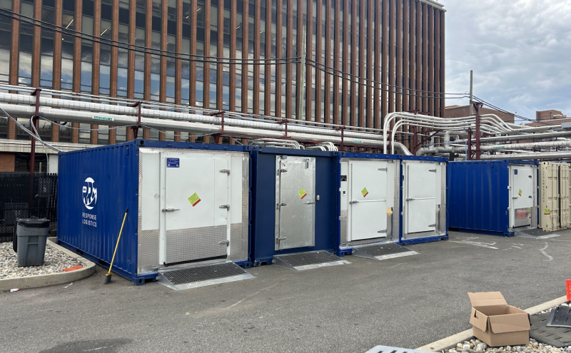 Line of blue refrigerated containers for convenience stores during refrigeration outages.