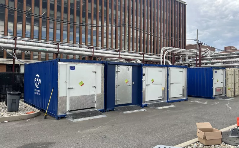 Line of blue refrigerated containers for convenience stores during refrigeration outages.