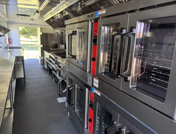 Inside view of a mobile emergency kitchen trailer for on-site catering.