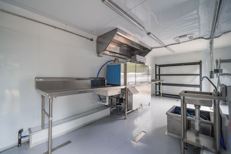 Interior of a high-capacity mobile kitchen featuring commercial-grade cooking equipment.