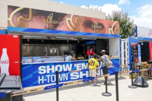 Branded container concession stand with guests ordering at the counter