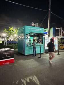 Teal container bar serving guests at night